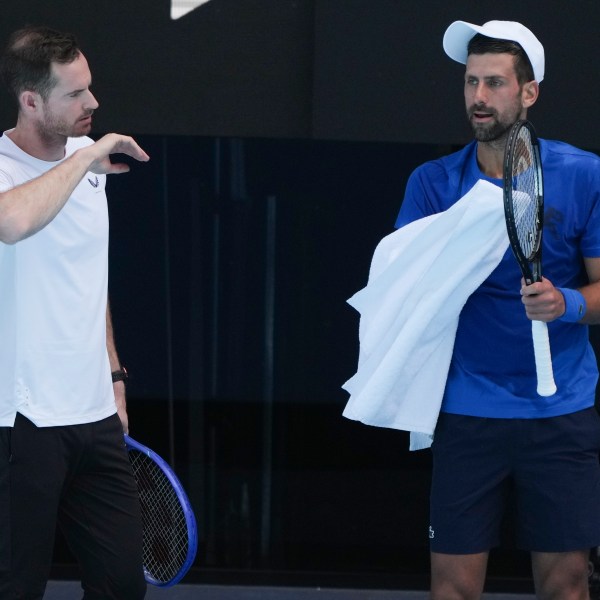 Serbia's Novak Djokovic talks with his coach Andy Murray, left, during a practice session ahead of the Australian Open tennis championship in Melbourne, Australia, Thursday, Jan. 9, 2025. (AP Photo/Mark Baker)