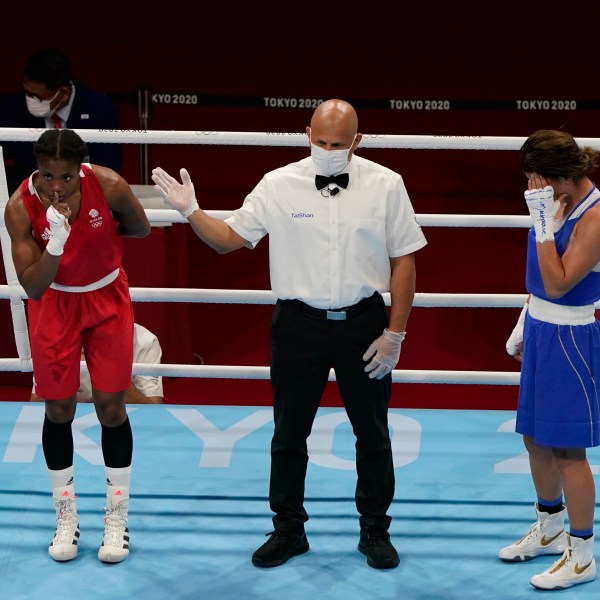 FILE -Caroline Dubois, of Great Britain, left, reacts after defeating Donjeta Sadiku, of Kosovo, right, in a light weight (60kg) preliminary boxing match at the 2020 Summer Olympics, July 27, 2021, in Tokyo, Japan. (AP Photo/ Frank Franklin II, File)