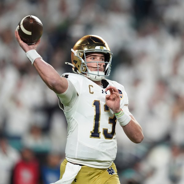 Notre Dame quarterback Riley Leonard (13) aims a pass during first half of the Orange Bowl NCAA College Football Playoff semifinal game against Penn State, Thursday, Jan. 9, 2025, in Miami Gardens, Fla. (AP Photo/Rebecca Blackwell)