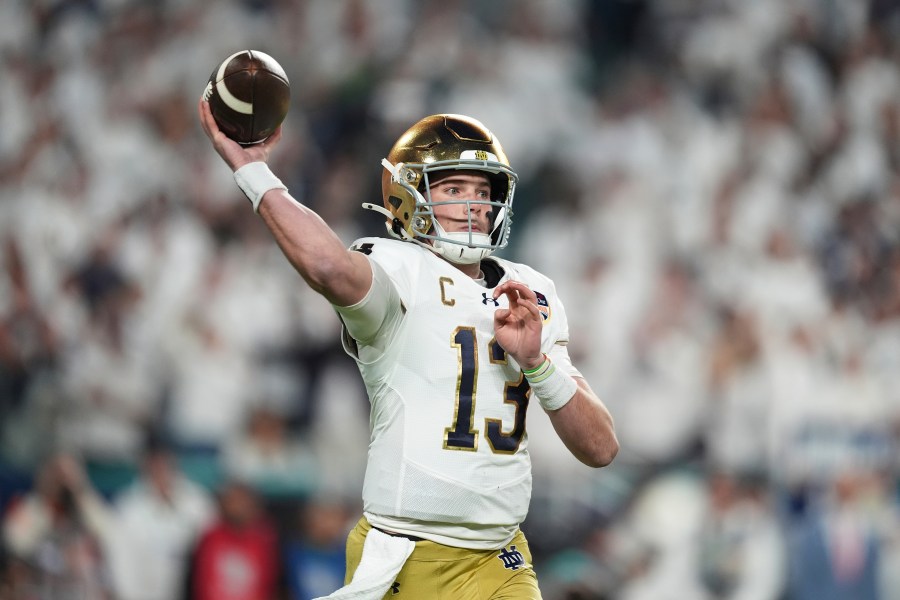 Notre Dame quarterback Riley Leonard (13) aims a pass during first half of the Orange Bowl NCAA College Football Playoff semifinal game against Penn State, Thursday, Jan. 9, 2025, in Miami Gardens, Fla. (AP Photo/Rebecca Blackwell)