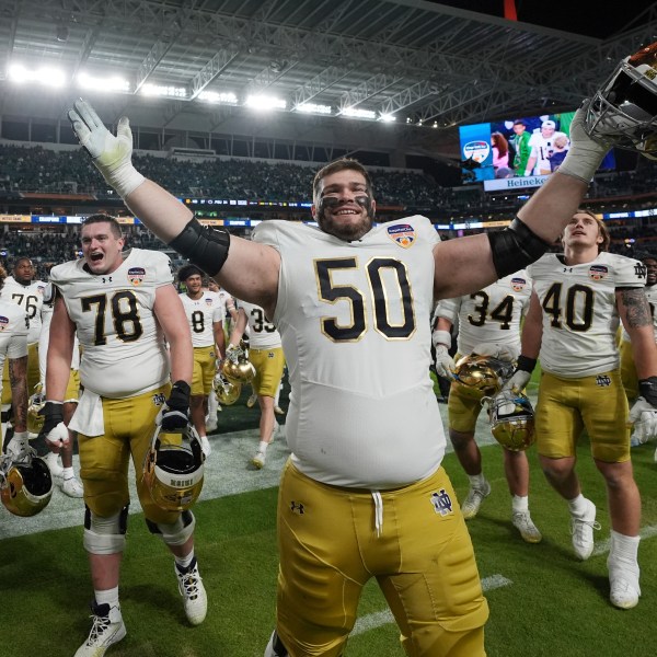 Notre Dame offensive lineman Rocco Spindler (50) celebrates at the end of the Orange Bowl College Football Playoff semifinal game against Penn State, Thursday, Jan. 9, 2025, in Miami Gardens, Fla. (AP Photo/Rebecca Blackwell)