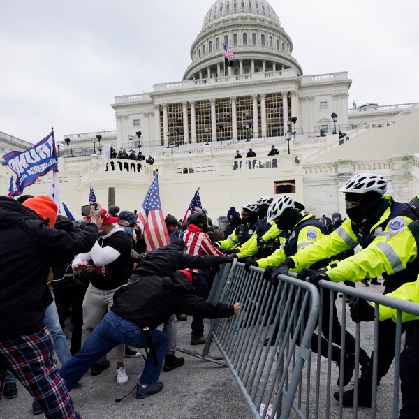 FILE - Insurrectionists loyal to President Donald Trump try to break through a police barrier, Wednesday, Jan. 6, 2021, at the Capitol in Washington. (AP Photo/Julio Cortez, File)