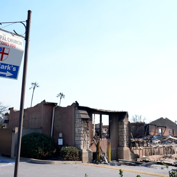 A welcome sign points to the charred remains of St. Mark's Episcopal Church after it was destroyed by the Eaton Fire, Friday, Jan. 10, 2025, in Altadena, Calif. (AP Photo/Chris Pizzello)