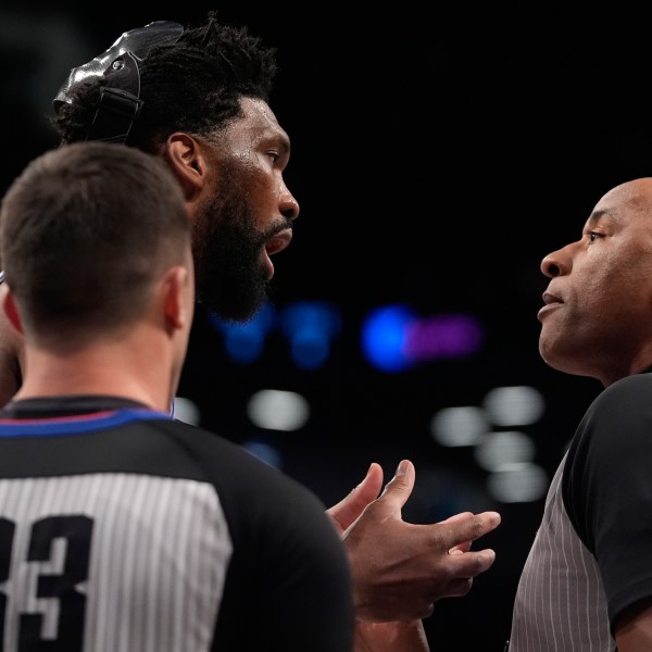 Philadelphia 76ers' Joel Embiid, left, argues a call with referee Kevin Cutler (34) during the first half of an NBA basketball game against the Brooklyn Nets Saturday, Jan. 4, 2025, in New York. (AP Photo/Frank Franklin II)