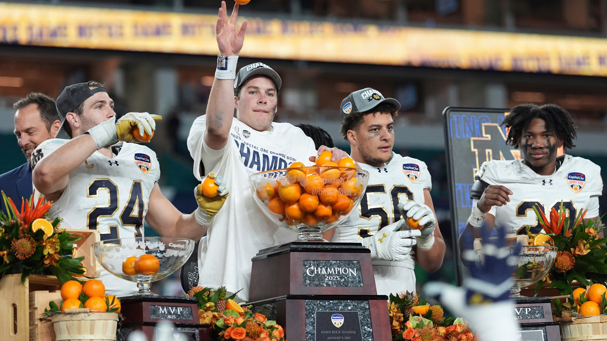 Notre Dame quarterback Riley Leonard throws oranges to his teammates after winning the Orange Bowl College Football Playoff semifinal game against Penn State, Thursday, Jan. 9, 2025, in Miami Gardens, Fla. (AP Photo/Rebecca Blackwell)