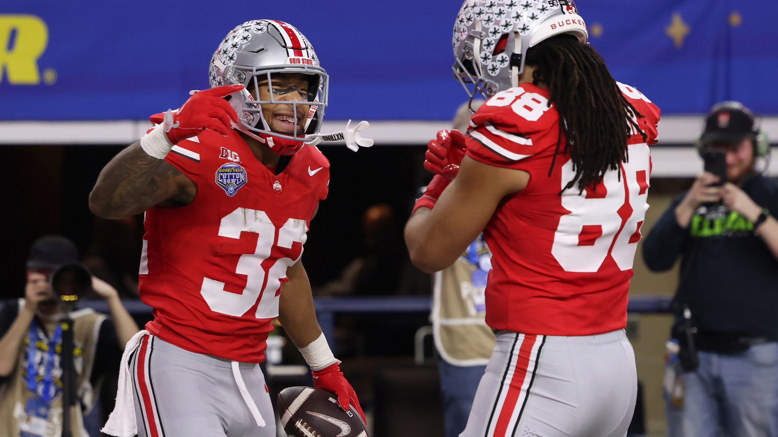 Ohio State running back TreVeyon Henderson (32) is congratulated by tight end Gee Scott Jr. (88) after scoring against Texas during the first half of the Cotton Bowl College Football Playoff semifinal game, Friday, Jan. 10, 2025, in Arlington, Texas. (AP Photo/Gareth Patterson)