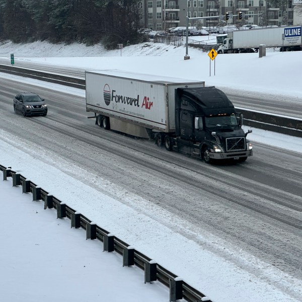 /// A truck picks its way along a slushy Interstate 285 northeast of downtown in Atlanta on Friday, Jan. 10, 2025. (AP Photo/Jeff Amy)