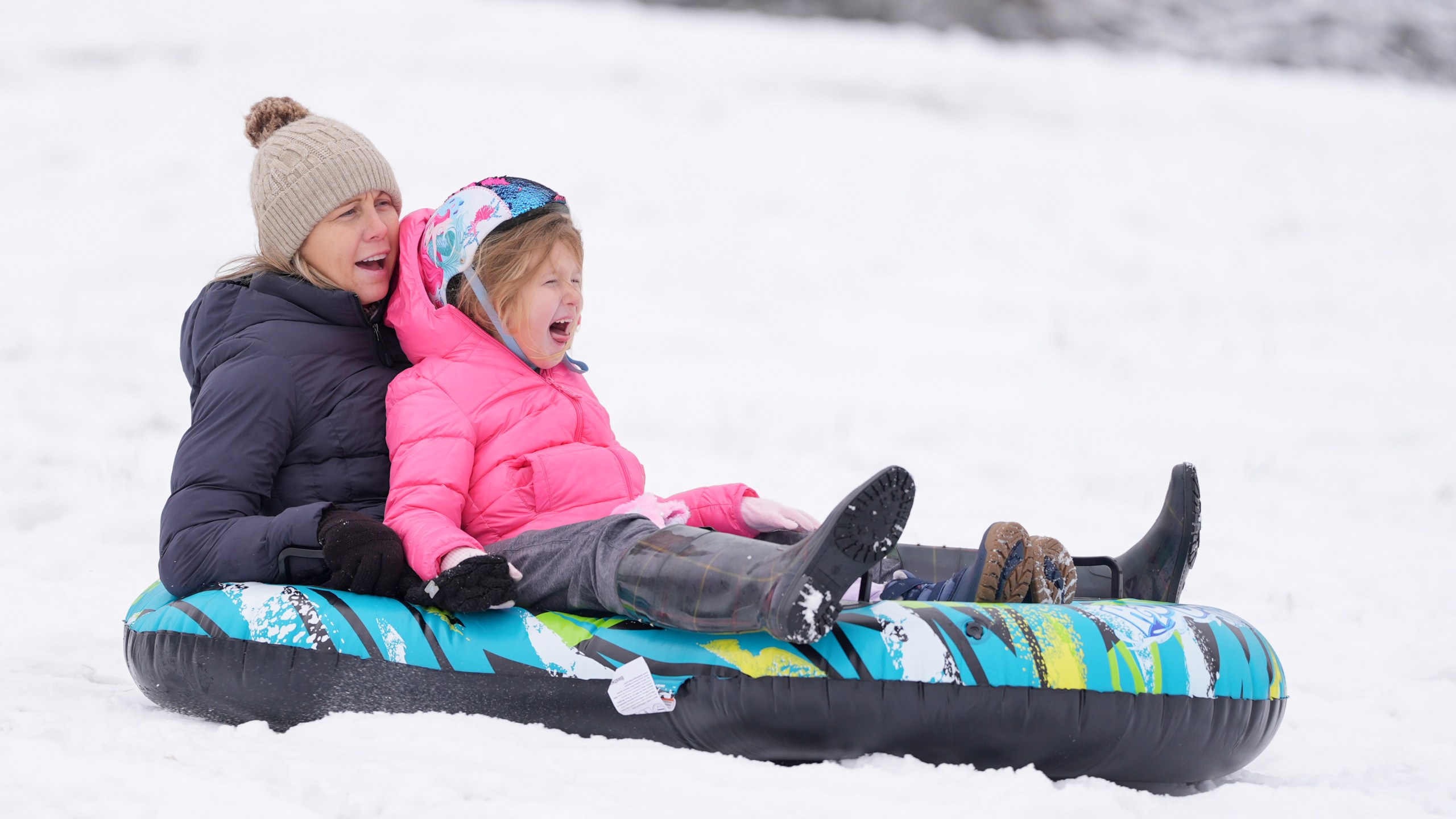 People sled down a snow covered hill Saturday, Jan. 11, 2025, in Nashville, Tenn. (AP Photo/George Walker IV)