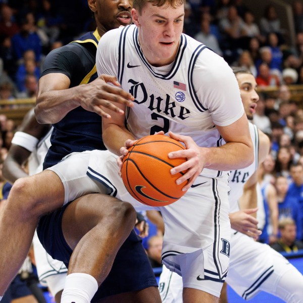 Duke's Cooper Flagg (2) grabs a rebound ahead of Notre Dame's Kebba Njie, left, during the first half of an NCAA college basketball game in Durham, N.C., Saturday, Jan. 11, 2025. (AP Photo/Ben McKeown)