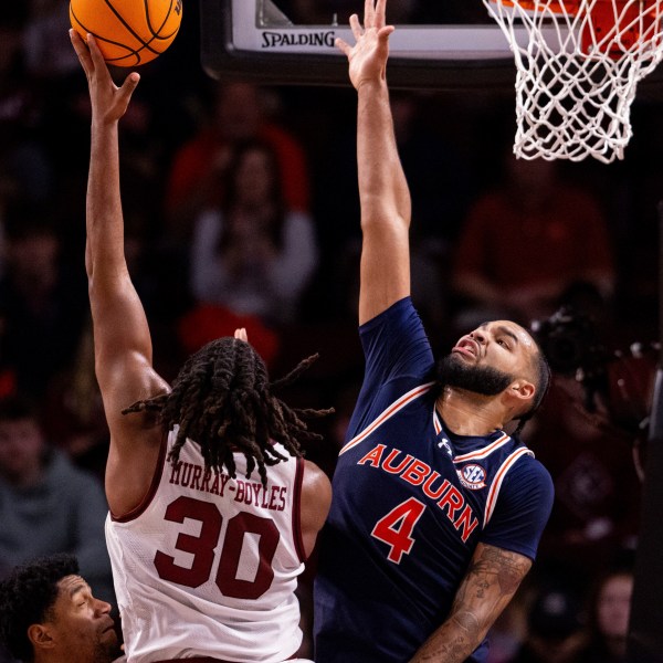 Carolina forward Collin Murray-Boyles, left, shoots over Auburn's Johni Broome (4) during the first half of an NCAA college basketball game on Saturday, Jan. 11, 2025, in Columbia, S.C. (AP Photo/Scott Kinser)