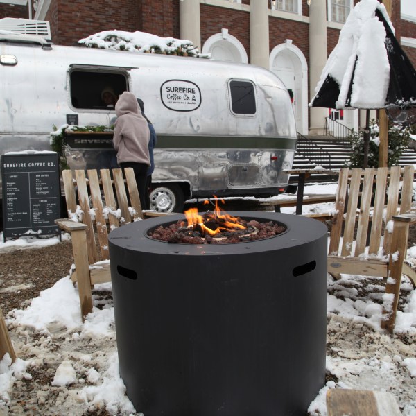 CORRECTS NAME OF RESTAURANT - People drink coffee outside of Surefire Coffee Co. after snow fell in the area in Nashville, Tenn. on Saturday, Jan.11, 2025. (AP Photo/Kristin M. Hall)