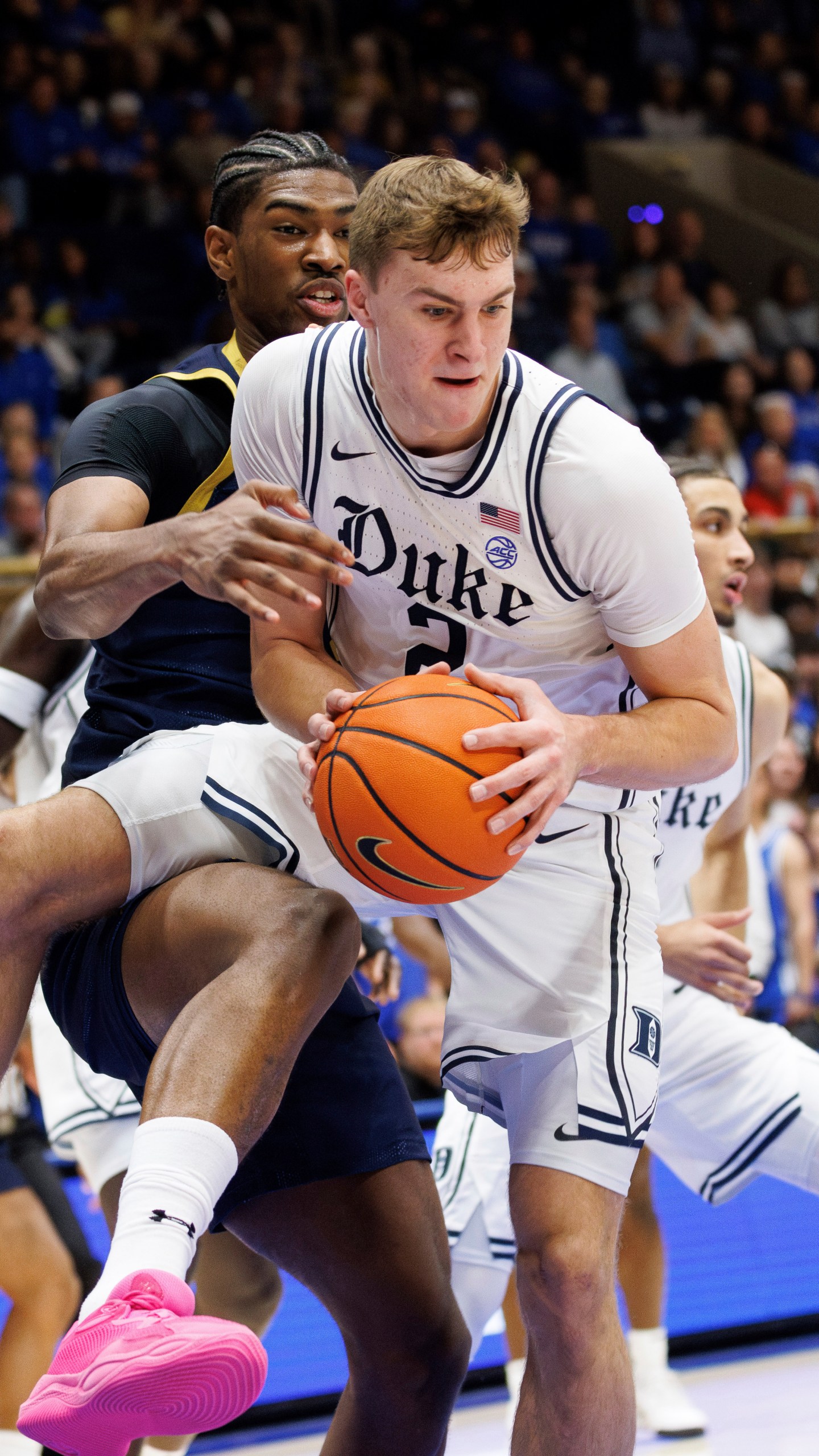 Duke's Cooper Flagg (2) grabs a rebound ahead of Notre Dame's Kebba Njie, left, during the first half of an NCAA college basketball game in Durham, N.C., Saturday, Jan. 11, 2025. (AP Photo/Ben McKeown)