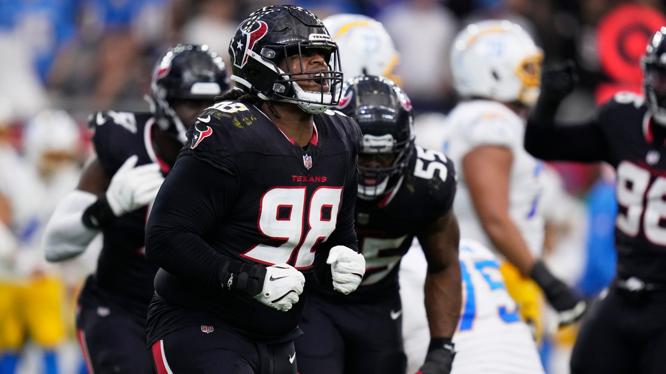 Houston Texans' Tim Settle Jr. (98) celebrates after the Texans stopped the Los Angeles Chargers on third down during the first half of an NFL wild-card playoff football game Saturday, Jan. 11, 2025, in Houston. (AP Photo/Eric Christian Smith)