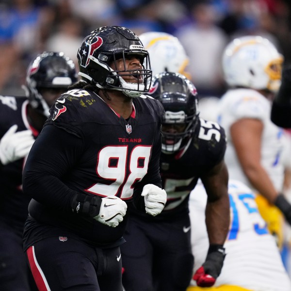 Houston Texans' Tim Settle Jr. (98) celebrates after the Texans stopped the Los Angeles Chargers on third down during the first half of an NFL wild-card playoff football game Saturday, Jan. 11, 2025, in Houston. (AP Photo/Eric Christian Smith)