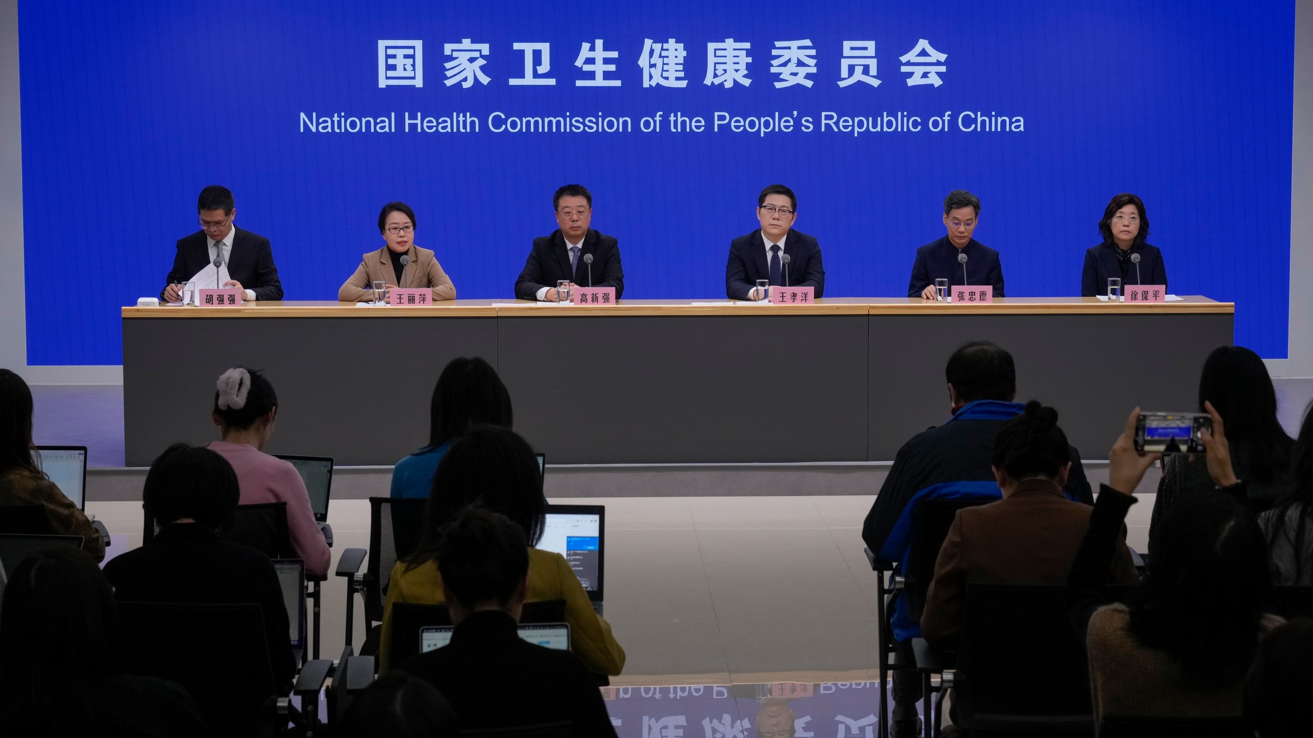 Wang Liping, second left, a researcher for the Chinese Center for Disease Control and Prevention speaks during a press briefing by the National Health Commission as concerns surfaced in recent days over a surge in HMPV infections in northern China after images circulated online of hospitals overrun with masked patients, in Beijing, Sunday, Jan. 12, 2025. (AP Photo/Andy Wong)