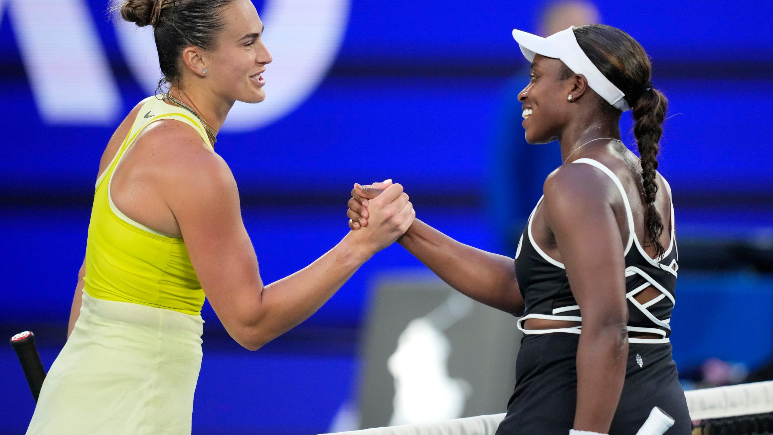 Aryna Sabalenka, left, of Belarus is congratulated by Sloane Stephens of the U.S. following their first round match at the Australian Open tennis championship in Melbourne, Australia, Sunday, Jan. 12, 2025. (AP Photo/Vincent Thian)