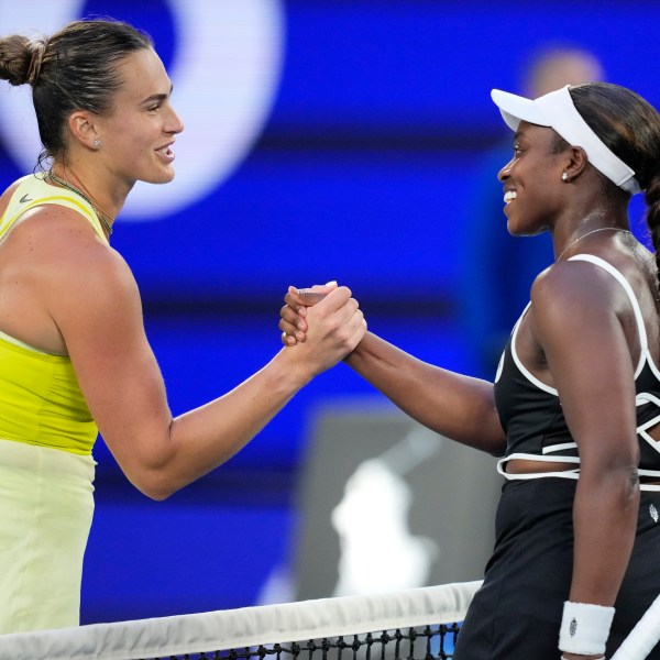 Aryna Sabalenka, left, of Belarus is congratulated by Sloane Stephens of the U.S. following their first round match at the Australian Open tennis championship in Melbourne, Australia, Sunday, Jan. 12, 2025. (AP Photo/Vincent Thian)