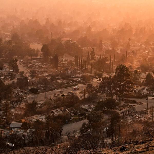 Smoke lingers over a neighborhood devastated by the Eaton Fire, Thursday, Jan. 9, 2025, in Altadena, Calif. (AP Photo/John Locher)