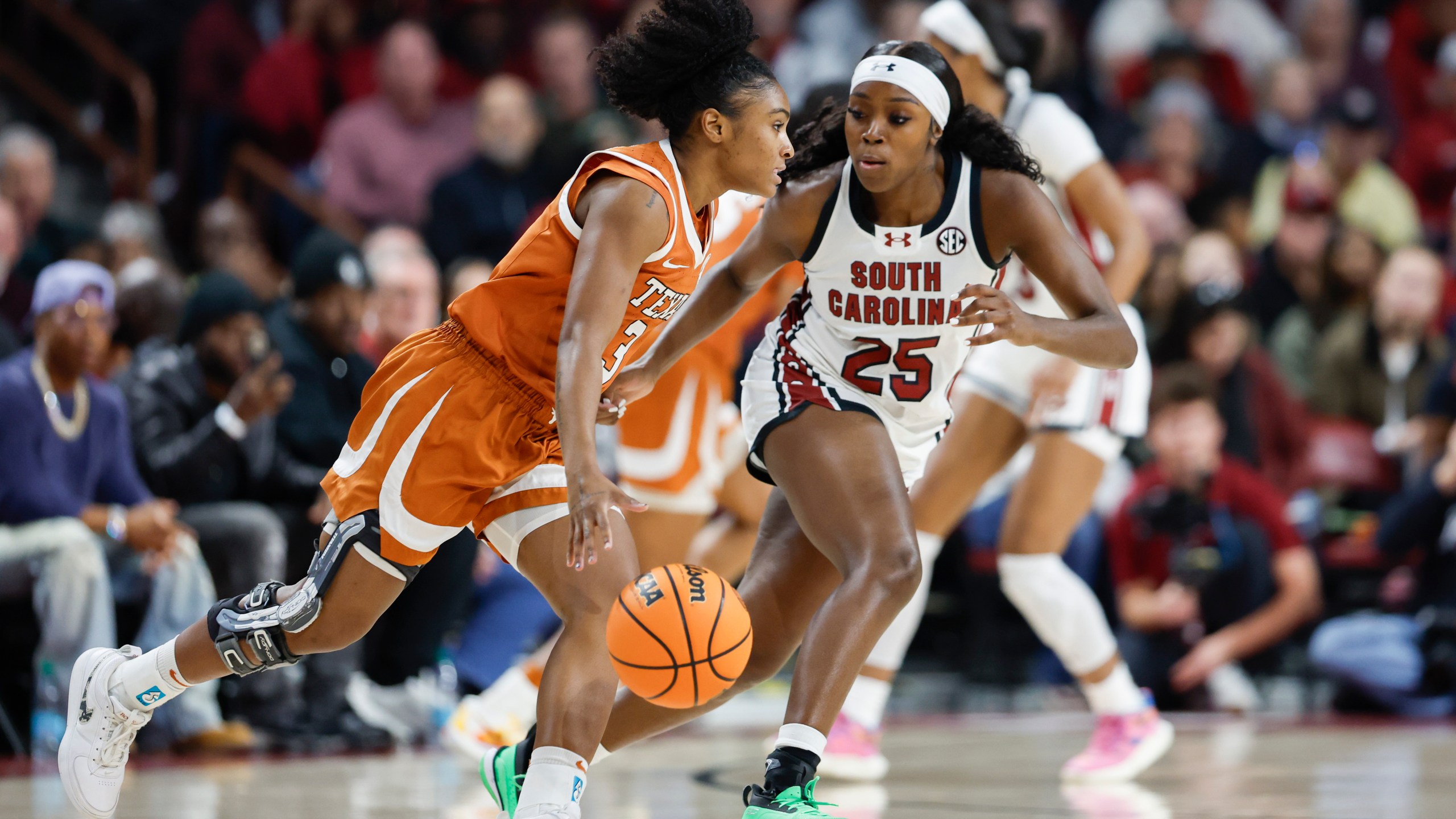 Texas guard Rori Harmon (3) drives against South Carolina guard Raven Johnson (25) during the first half of an NCAA college basketball game in Columbia, S.C., Sunday, Jan. 12, 2025. (AP Photo/Nell Redmond)