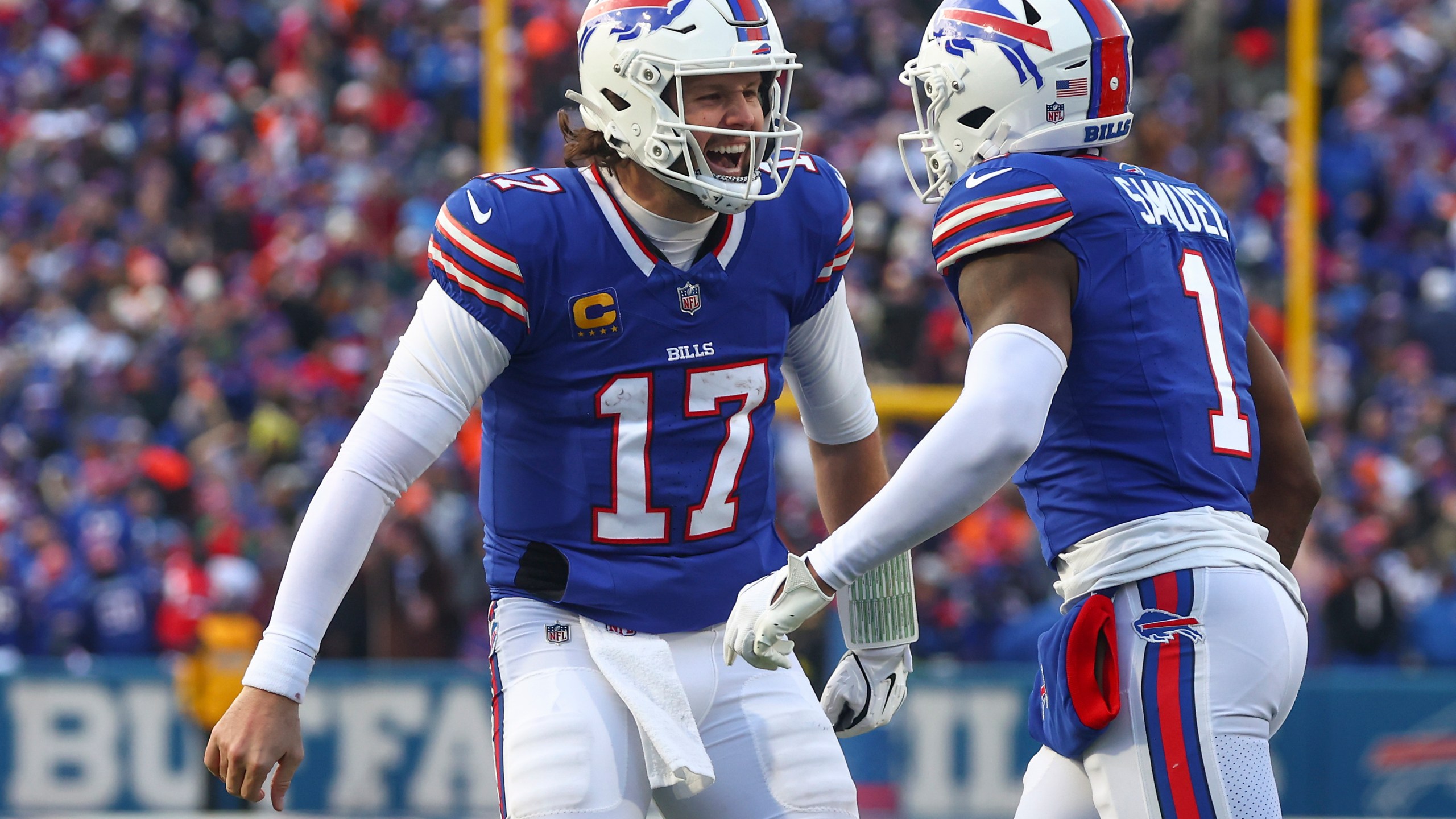 Buffalo Bills quarterback Josh Allen (17) celebrates with wide receiver Curtis Samuel (1) after Samuel scored a touchdown against the Denver Broncos during the fourth quarter of an NFL wild card playoff football game, Sunday, Jan. 12, 2025, in Orchard Park, N.Y. (AP Photo/Jeffrey T. Barnes)