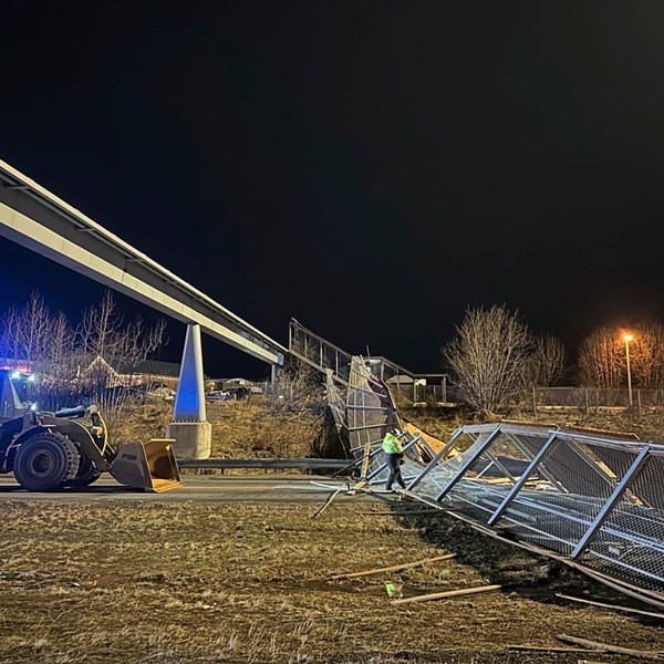 This image provided by the Alaska Department of Transportation & Public Facilities shows fencing and the roof of a walkway after collapsing onto the Seward Highway in Anchorage, Alaska, on Sunday, Jan. 12, 2025. (Alaska Department of Transportation & Public Facilities via AP)