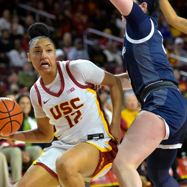 Southern California guard JuJu Watkins, left, drives past Penn State guard Moriah Murray, front right, during the second half of an NCAA college basketball game Sunday, Jan. 12, 2025, in Los Angeles. (AP Photo/Jayne Kamin-Oncea)