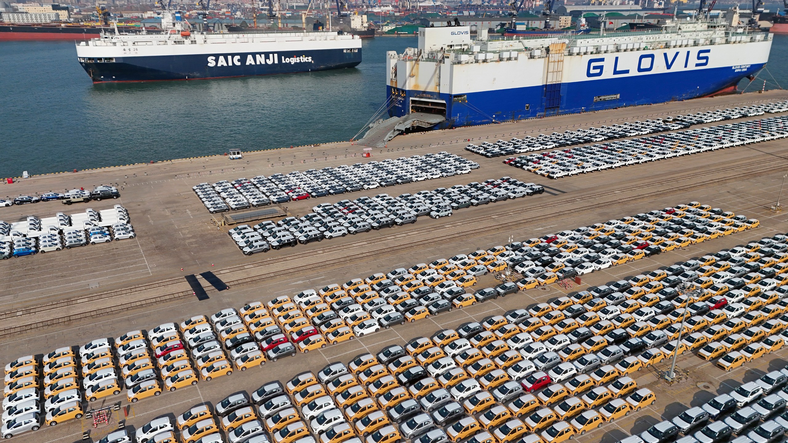 Vehicles and trucks for export wait for transportation from a port in Yantai in eastern China's Shandong province on Jan. 2, 2025. (Chinatopix via AP)