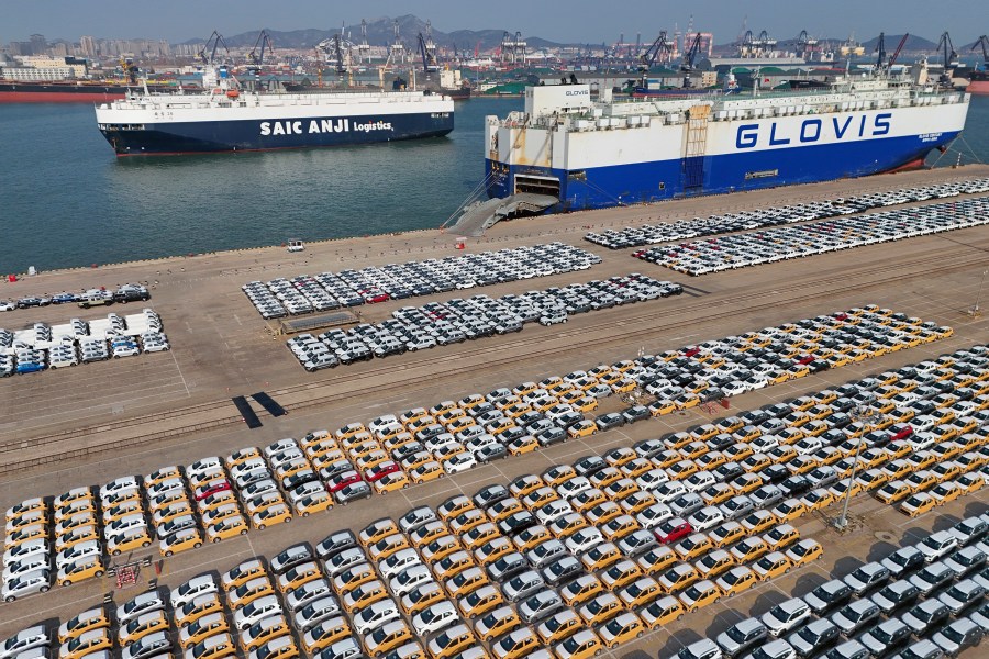 Vehicles and trucks for export wait for transportation from a port in Yantai in eastern China's Shandong province on Jan. 2, 2025. (Chinatopix via AP)