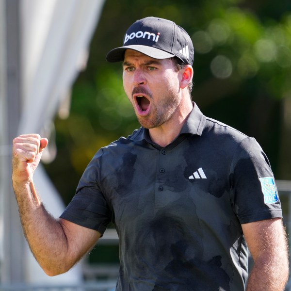 Nick Taylor, of Canada, celebrates after making a shot on the 18th green during the final round of the Sony Open golf event, Sunday, Jan. 12, 2025, at Waialae Country Club in Honolulu. (AP Photo/Matt York)