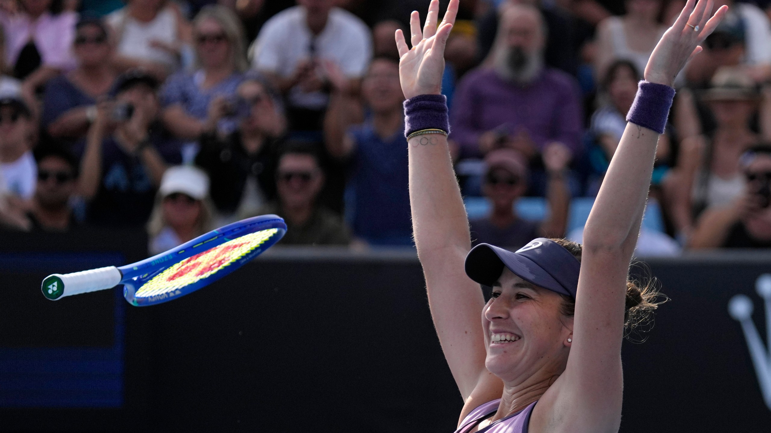 Belinda Bencic of Switzerland celebrates after defeating Jelena Ostapenko of Latvia in their first round match at the Australian Open tennis championship in Melbourne, Australia, Monday, Jan. 13, 2025. (AP Photo/Vincent Thian)