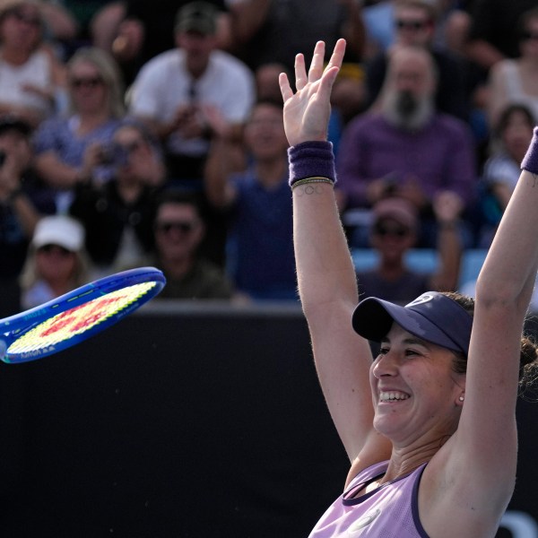 Belinda Bencic of Switzerland celebrates after defeating Jelena Ostapenko of Latvia in their first round match at the Australian Open tennis championship in Melbourne, Australia, Monday, Jan. 13, 2025. (AP Photo/Vincent Thian)