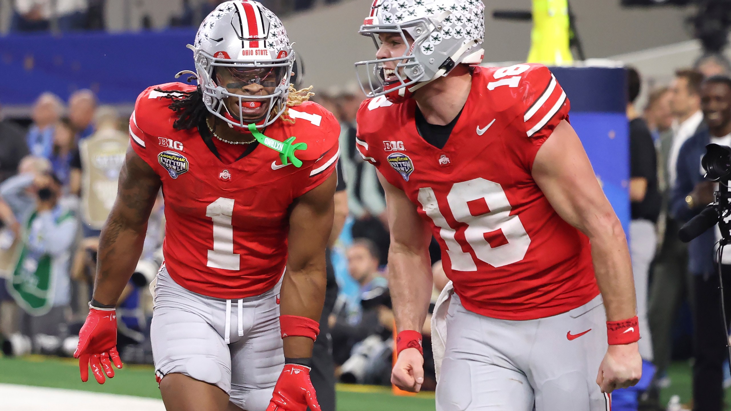 Ohio State running back Quinshon Judkins (1) celebrates after scoring a touchdown with quarterback Will Howard (18) during the second half of the Cotton Bowl College Football Playoff semifinal game against Texas, Friday, Jan. 10, 2025, in Arlington, Texas. (AP Photo/Gareth Patterson)