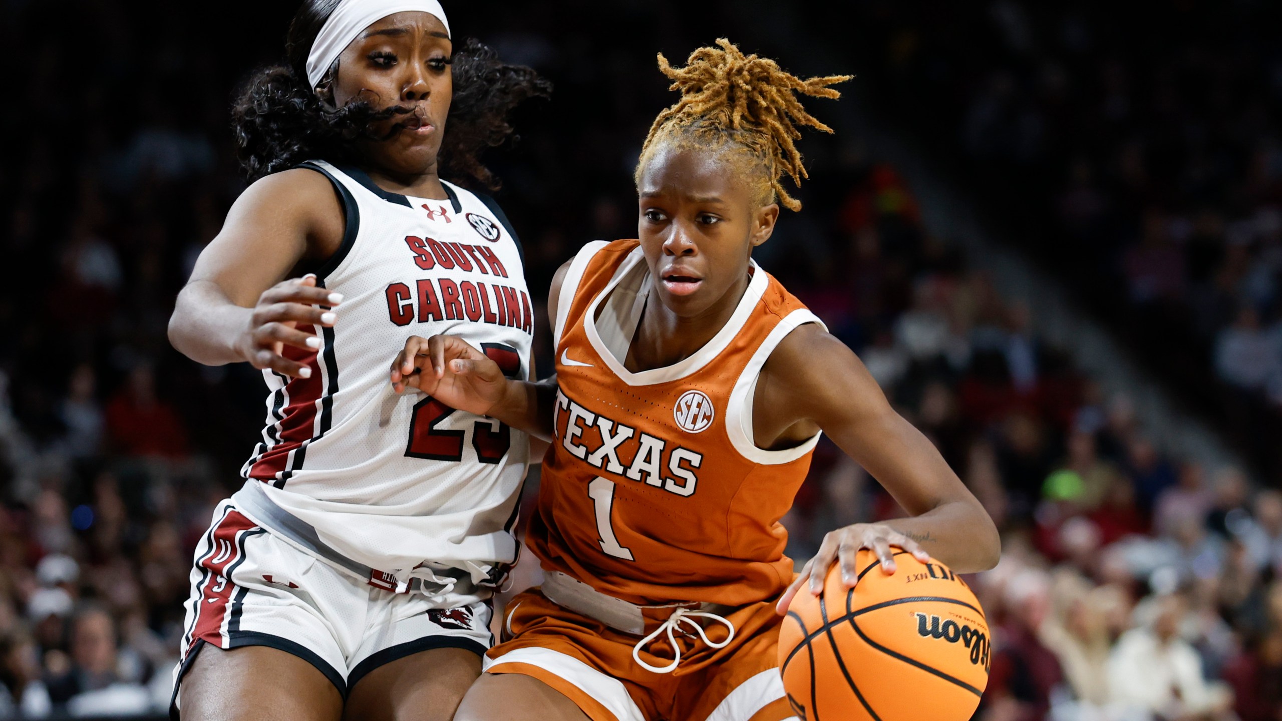 Texas guard Bryanna Preston (1) drives against South Carolina guard Raven Johnson during the second half of an NCAA college basketball game in Columbia, S.C., Sunday, Jan. 12, 2025. (AP Photo/Nell Redmond)