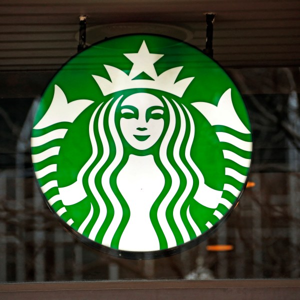 FILE - A Starbucks logo sign in the window of one of the chain's cafes in Pittsburgh, Jan. 12, 2017. (AP Photo/Gene J. Puskar, File)