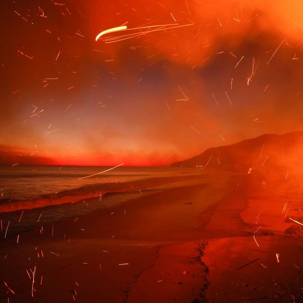 FILE - The Palisades Fire burns a beach front property, Jan. 8, 2025, in Malibu, Calif. (AP Photo/Etienne Laurent, File)