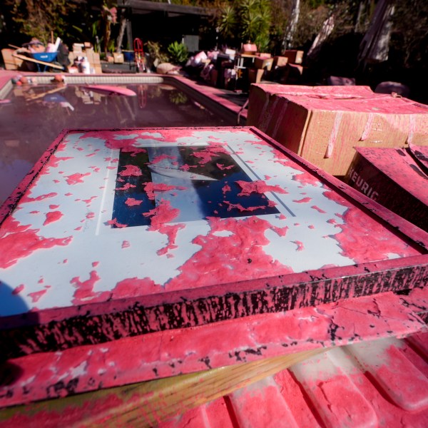 Retardant covers a framed photograph after crews battled the Palisades Fire in Mandeville Canyon Monday, Jan 13, 2025 in Los Angeles. (AP Photo/Richard Vogel)