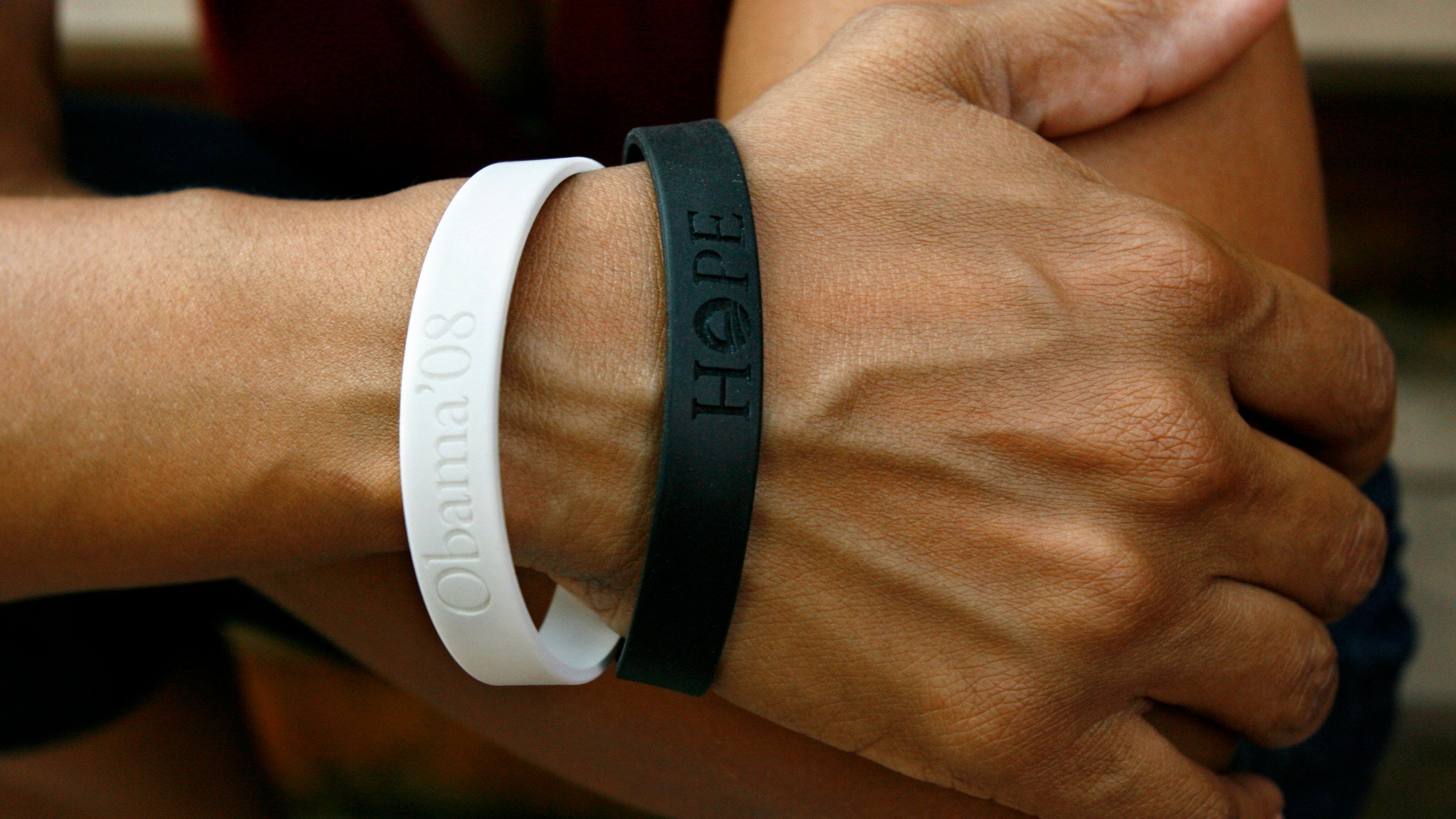 FILE - Rachel Lerman wears two bracelets supporting Sen. Barack Obama's candidacy for President, at her home in Washington, June 11, 2008. (AP Photo/Jacquelyn Martin, File)