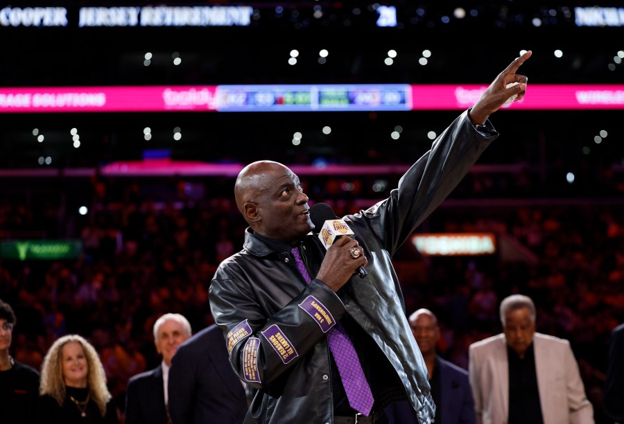 Former Los Angeles Lakers player Michel Cooper, center, gestures during his jersey retirement ceremony during halftime in a NBA basketball game between the Los Angeles Lakers and the San Antonio Spurs, Monday, Jan. 13, 2025, in Los Angeles. (AP Photo/Kevork Djansezian)