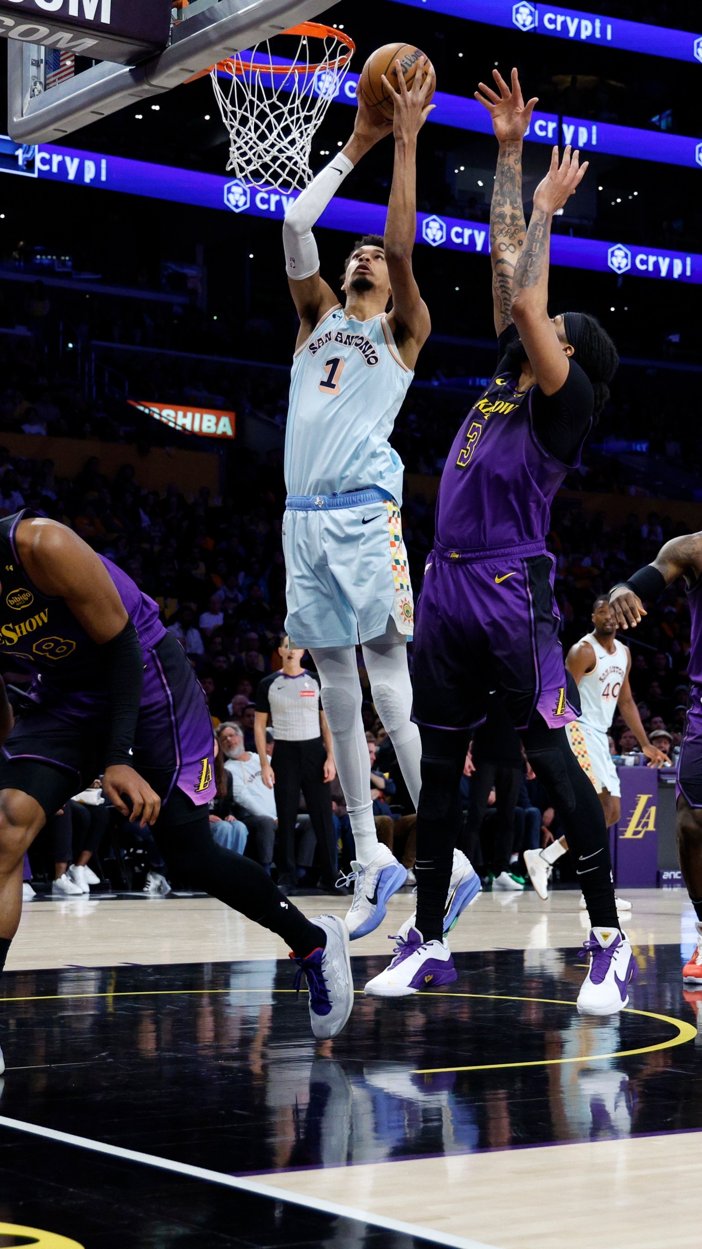 San Antonio Spurs center Victor Wembanyama (1) goes up to score against Los Angeles Lakers forward Anthony Davis (3) during the first quarter of an NBA basketball game Monday, Jan. 13, 2025, in Los Angeles. (AP Photo/Kevork Djansezian)