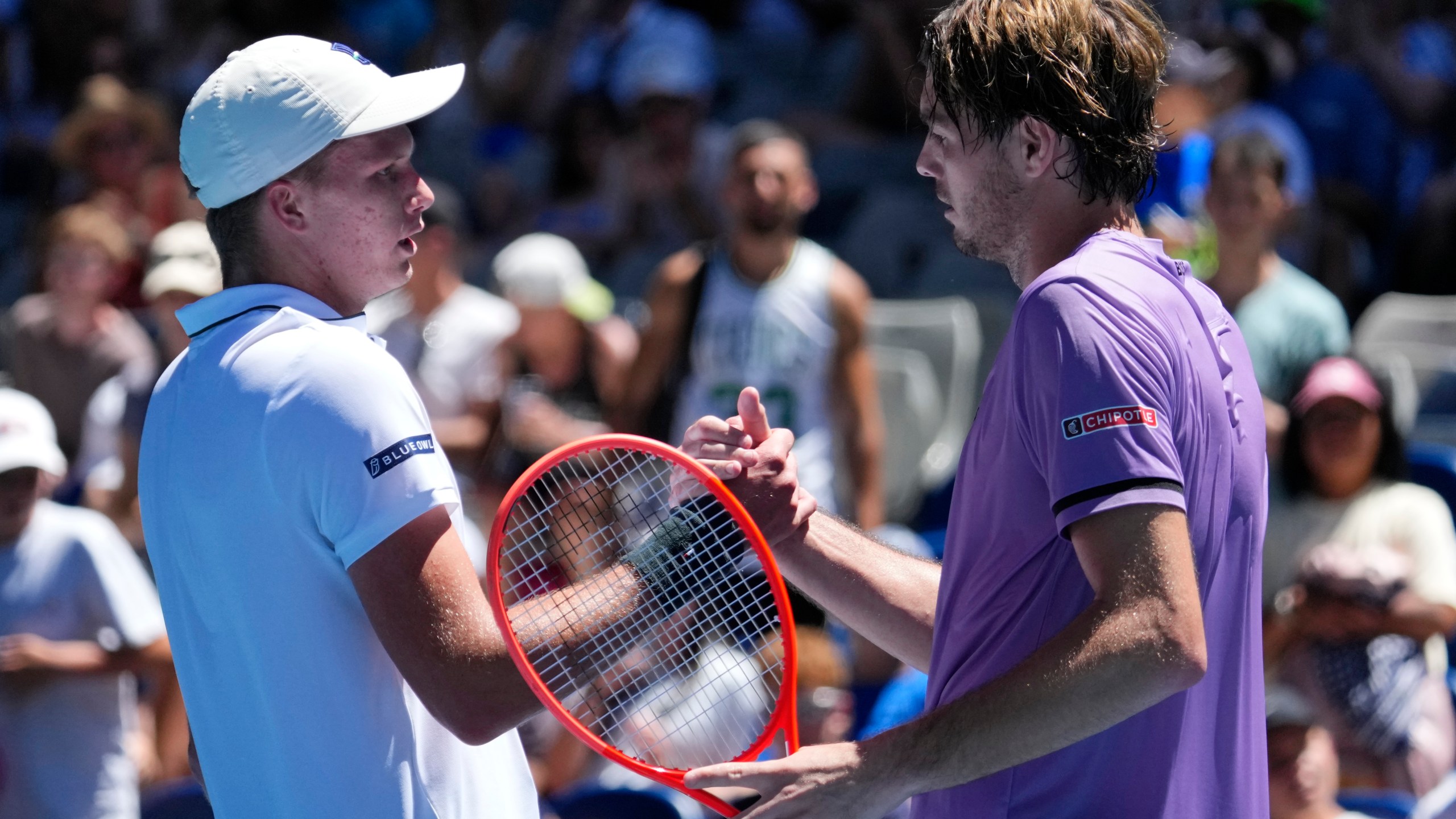 Taylor Fritz, right, of the U.S. is congratulated by compatriot Jenson Brooksby following their first round match at the Australian Open tennis championship in Melbourne, Australia, Tuesday, Jan. 14, 2025. (AP Photo/Vincent Thian)