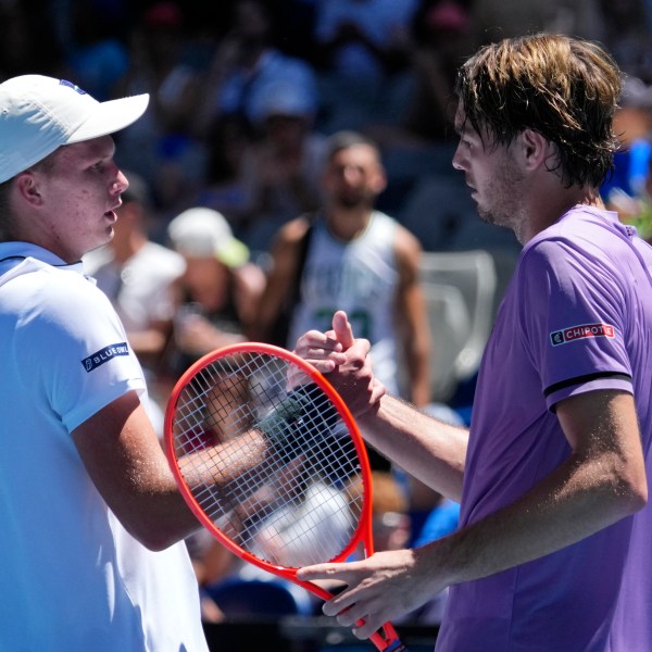 Taylor Fritz, right, of the U.S. is congratulated by compatriot Jenson Brooksby following their first round match at the Australian Open tennis championship in Melbourne, Australia, Tuesday, Jan. 14, 2025. (AP Photo/Vincent Thian)