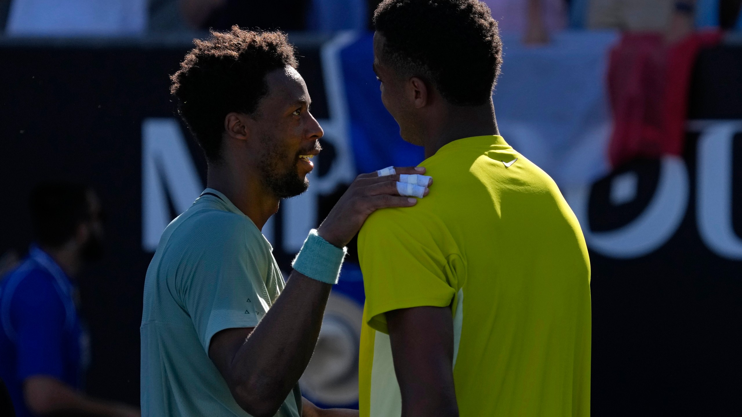 Gael Monfils, left, of France is congratulated by compatriot Giovanni Mpetshi Perricard following their first round match at the Australian Open tennis championship in Melbourne, Australia, Tuesday, Jan. 14, 2025. (AP Photo/Manish Swarup)