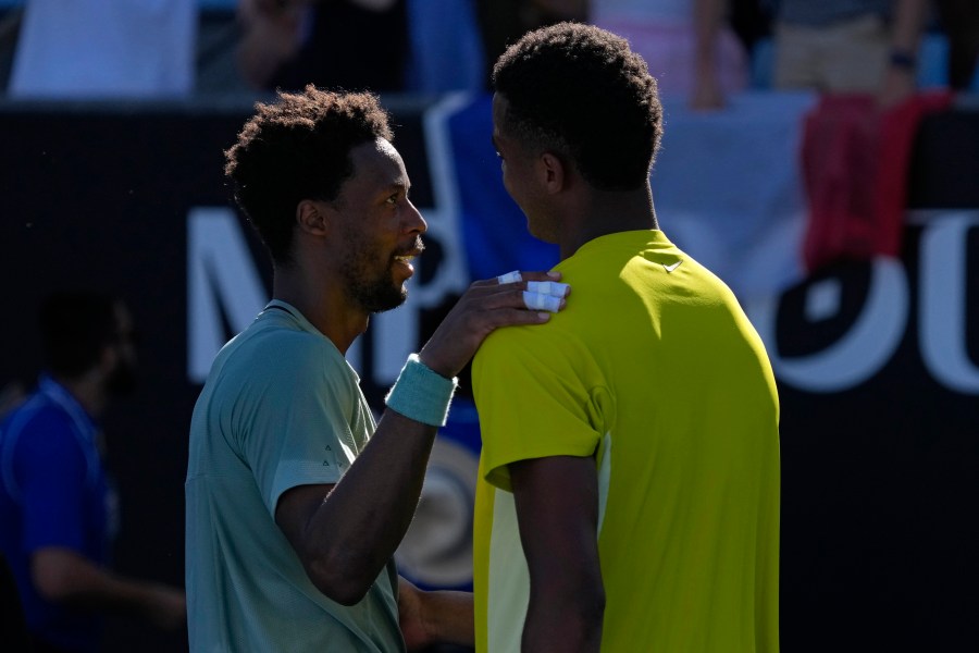 Gael Monfils, left, of France is congratulated by compatriot Giovanni Mpetshi Perricard following their first round match at the Australian Open tennis championship in Melbourne, Australia, Tuesday, Jan. 14, 2025. (AP Photo/Manish Swarup)