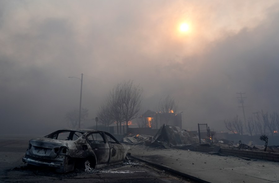 FILE - A burned-out car sits among rubble in the downtown Altadena section of Pasadena, Calif., Jan. 8, 2025. (AP Photo/Chris Pizzello, File)