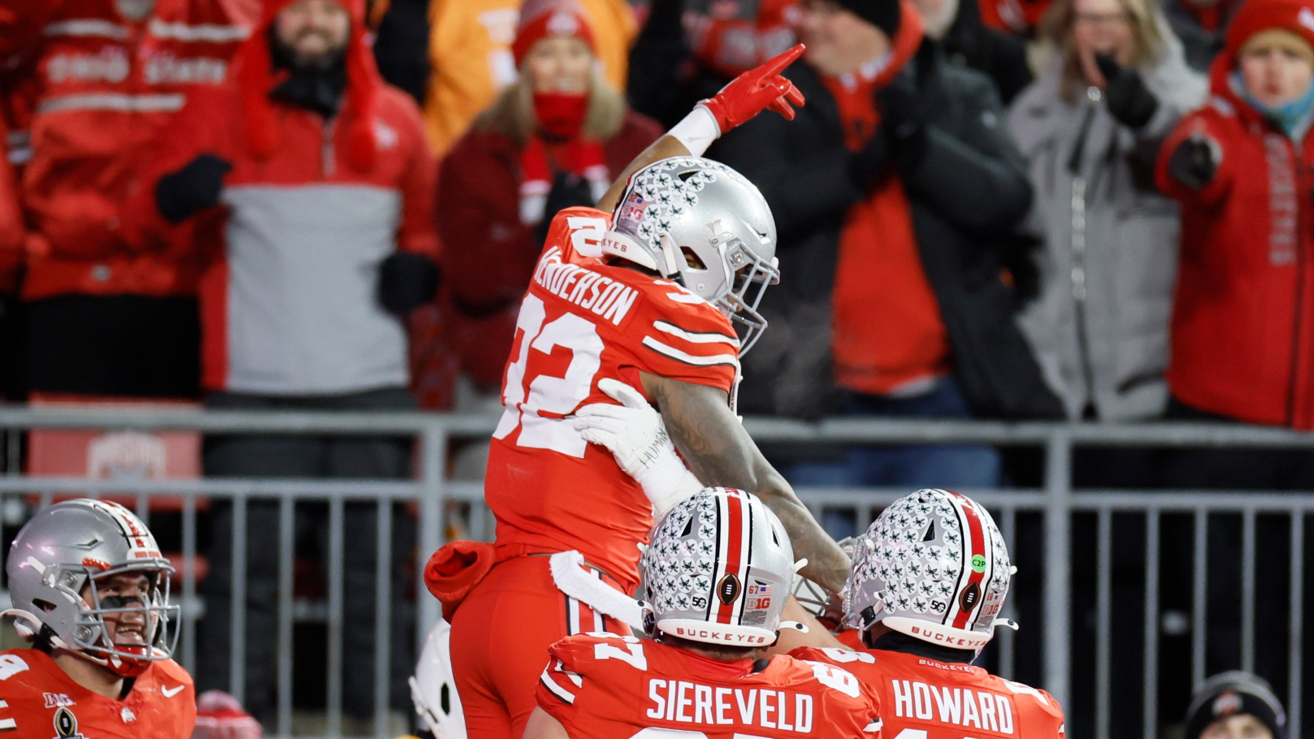 FILE - Ohio State running back TreVeyon Henderson, top, celebrates after his touchdown against Tennessee during the first half in the first round of the College Football Playoff, Saturday, Dec. 21, 2024, in Columbus, Ohio. (AP Photo/Jay LaPrete, File)