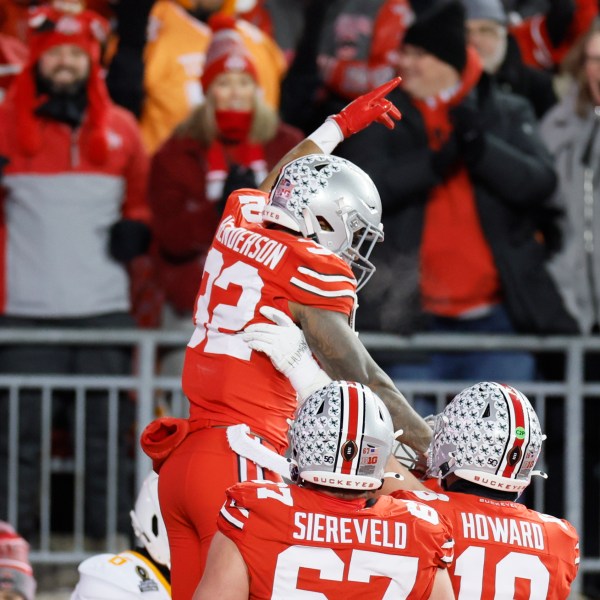 FILE - Ohio State running back TreVeyon Henderson, top, celebrates after his touchdown against Tennessee during the first half in the first round of the College Football Playoff, Saturday, Dec. 21, 2024, in Columbus, Ohio. (AP Photo/Jay LaPrete, File)