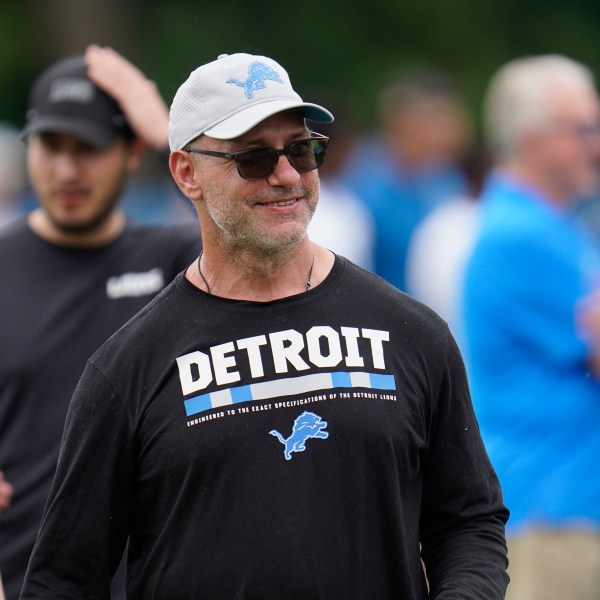 FILE - In this June 10, 2021, file photo, Chris Spielman, Detroit Lions special assistant to the chairman, watches during the team's NFL football practice in Allen Park, Mich. (AP Photo/Paul Sancya, File)