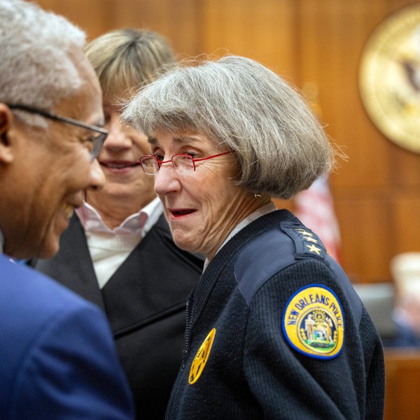 New Orleans Police Superintendent Anne Kirkpatrick, center, chats with U.S. Justice Department deputy monitor David Douglass, left, in Federal Court, Tuesday, Jan. 14, 2025, in New Orleans, after a judge ruled the New Orleans Police Department can begin the process of ending longstanding federal oversight. (Chris Granger/The Times-Picayune/The New Orleans Advocate via AP)