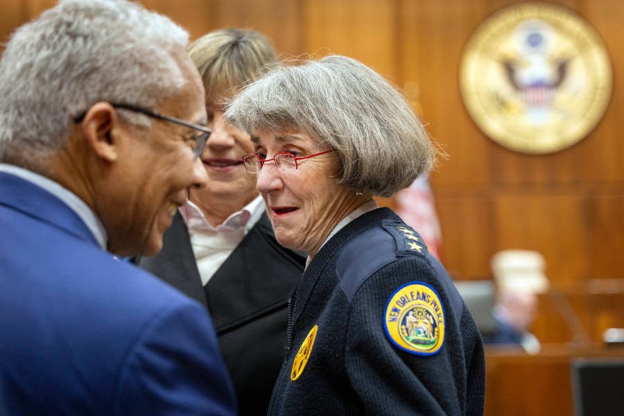 New Orleans Police Superintendent Anne Kirkpatrick, center, chats with U.S. Justice Department deputy monitor David Douglass, left, in Federal Court, Tuesday, Jan. 14, 2025, in New Orleans, after a judge ruled the New Orleans Police Department can begin the process of ending longstanding federal oversight. (Chris Granger/The Times-Picayune/The New Orleans Advocate via AP)