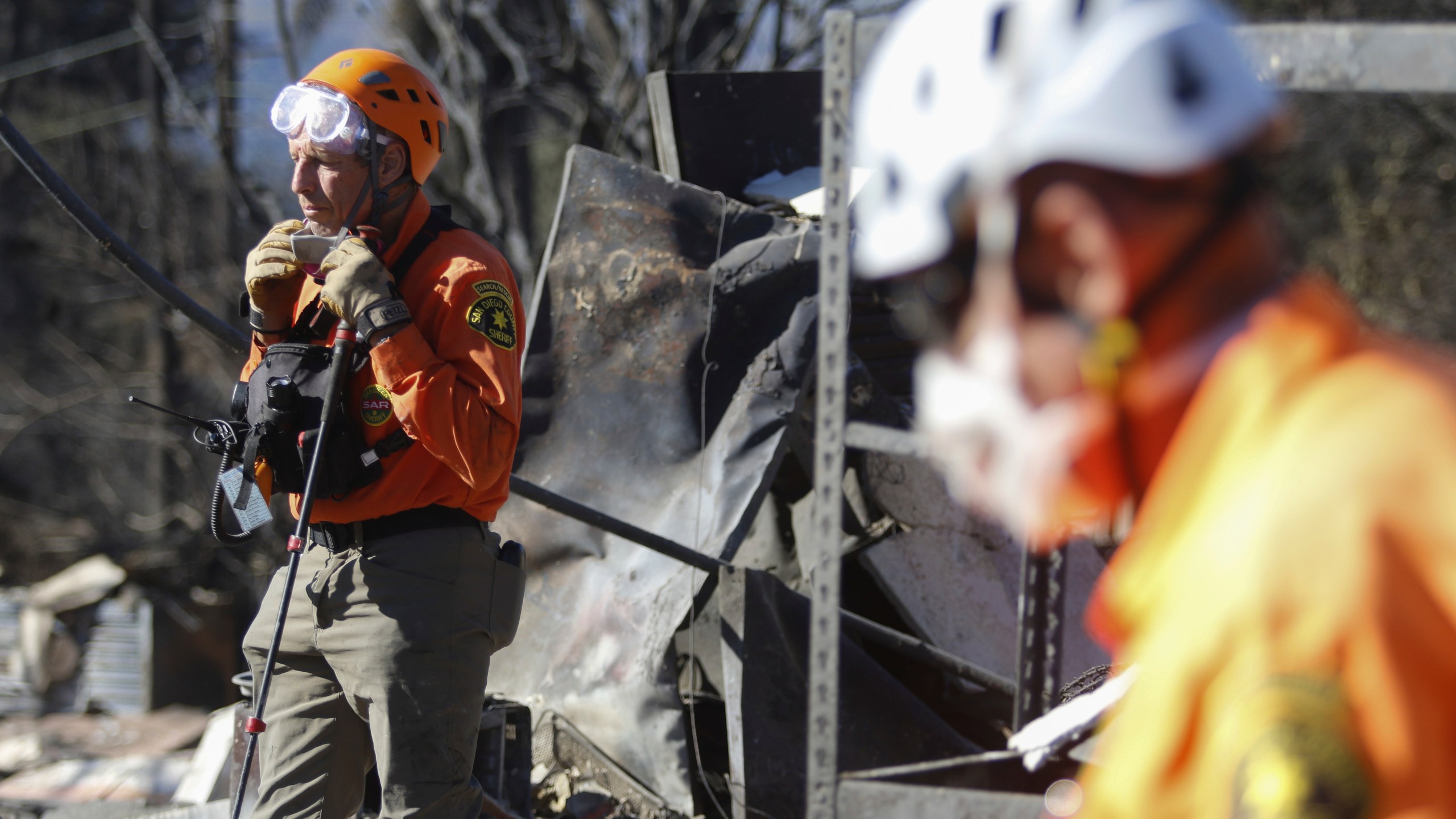 Search and rescue workers dig through the rubble left behind by the Eaton Fire, in Altadena, Calif., Tuesday, Jan. 14, 2025. (AP Photo/Ty O'Neil)